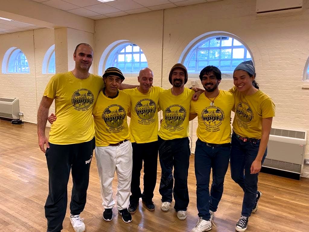 Capoeira Angola teachers and students standing together after an event