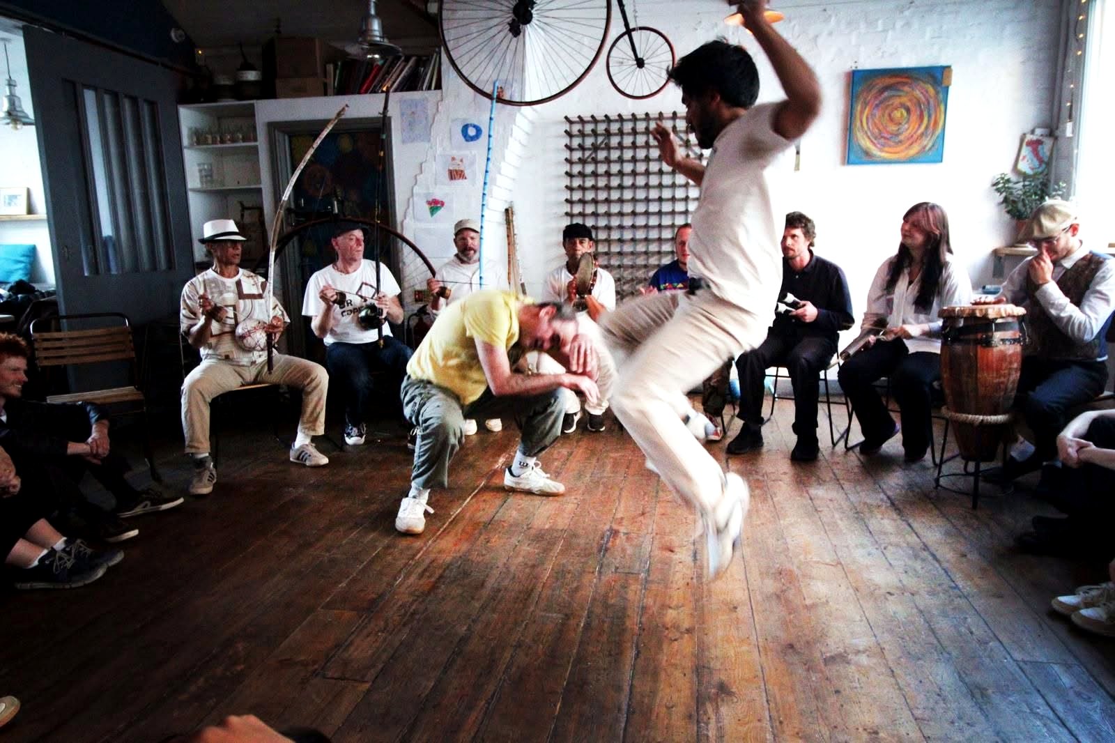 Capoeira Angola roda with live music in an indoor cultural space
